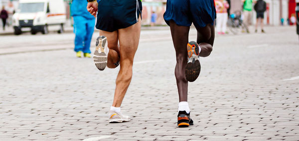 Low section of people walking on road