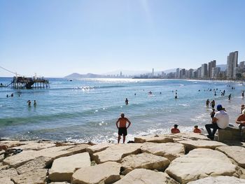 Panoramic view of man standing on beach against clear sky