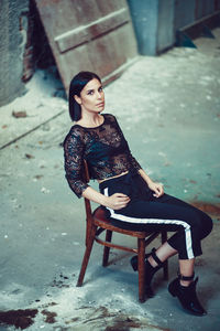 Portrait of young woman in abandoned room