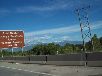 Road sign against sky