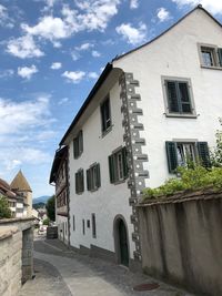 Street amidst buildings in town against sky