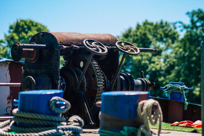 Close-up of machine part against sky