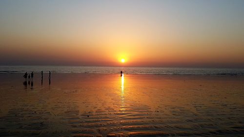 Scenic view of beach against sky during sunset