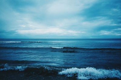 Scenic view of sea against cloudy sky