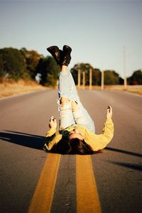 Man riding skateboard on road