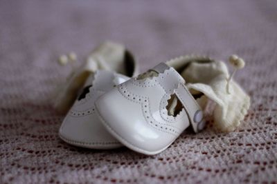 Close-up of white shoes on textile