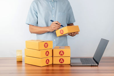 Midsection of man with toy blocks on table