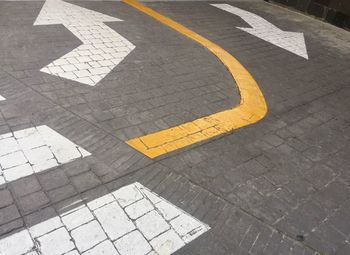 High angle view of arrow symbol on street