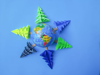Low angle view of star shapes on blue background