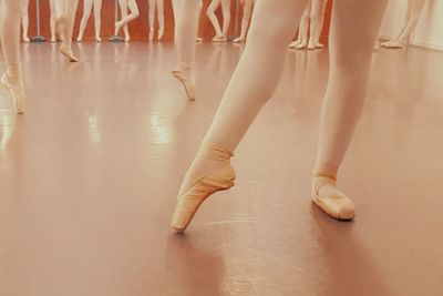Low section of ballerinas practicing in dance studio