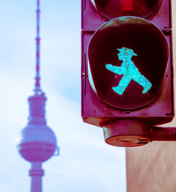 Close-up of road sign against sky