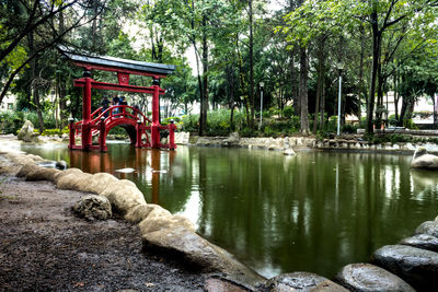 Built structure by trees in water