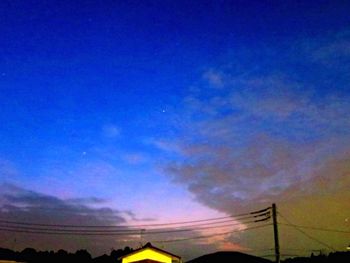 Low angle view of vapor trails in sky at night