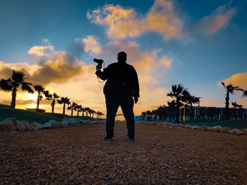 Man photographing at sunset