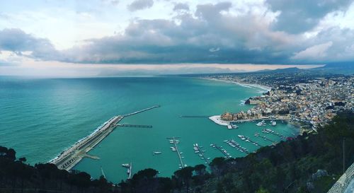 High angle view of sea and city against sky