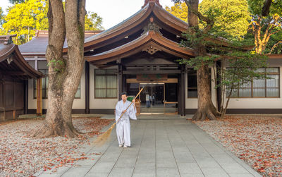 Woman outside temple against building