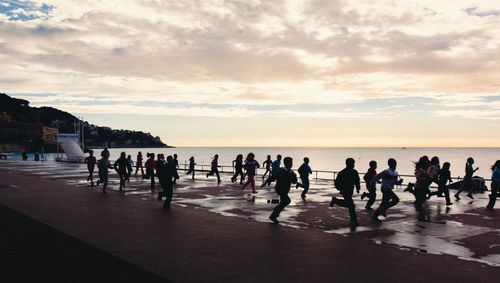 People on beach against sky