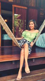 Portrait of a smiling young woman sitting outdoors