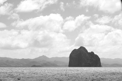 Scenic view of sea and rock formation against sky