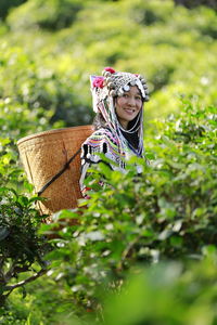 Rear view of woman wearing mask against trees