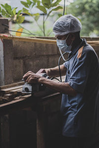 Man working on barbecue grill