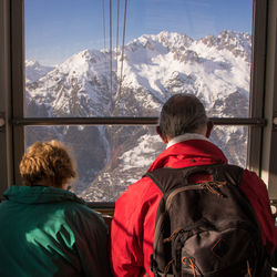 Two people in a high mountain cable car