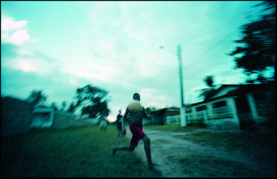 Full length of man on street in city against sky