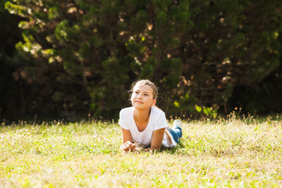 Portrait of boy sitting on field