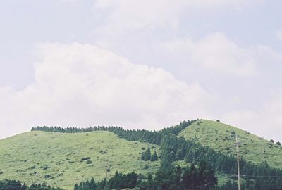 Scenic view of mountains against cloudy sky