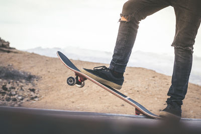 Low section of man skateboarding in park