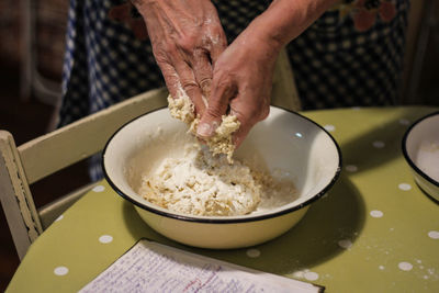 Midsection of woman preparing food on table