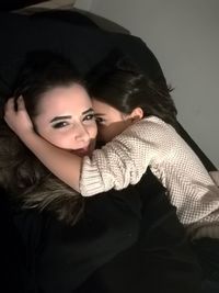 Portrait of beautiful young woman against gray background