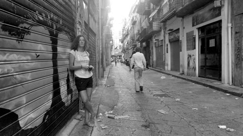 Rear view of people walking on street