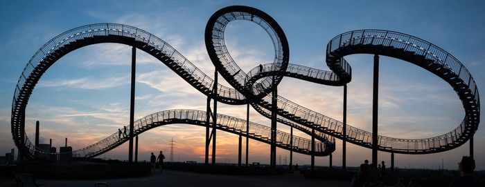 Low angle view of rollercoaster against sky