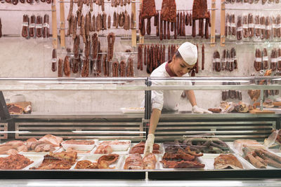 Man working on display at store