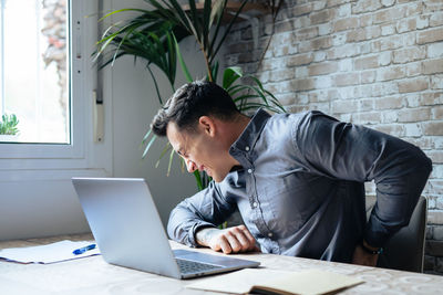Young man using laptop at office