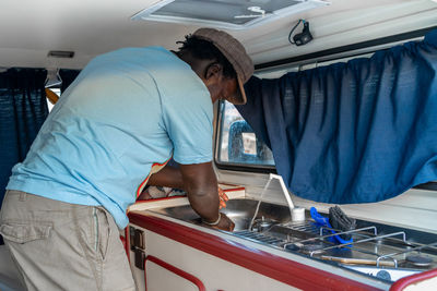 African american man cooking in a camper van