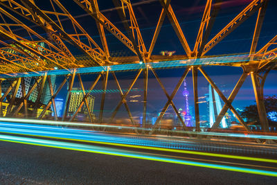 Light trails on bridge in city at night