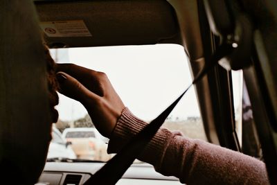 Midsection of man using mobile phone in car