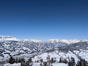 Scenic view of snowcapped mountains against clear blue sky