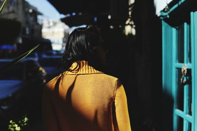 Rear view of woman standing at night