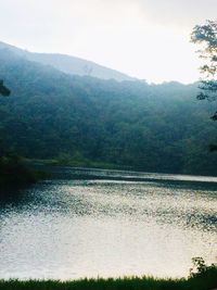 Scenic view of river amidst mountains against sky