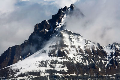 Low angle view of rocky mountains during winter at gran paradiso national park