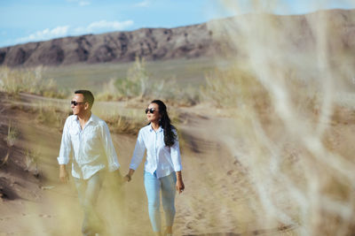 Couple walking on top of mountain landscape