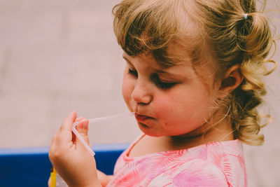 Close-up portrait of cute girl looking down