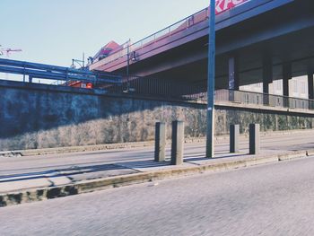 Bridge over road in city against sky