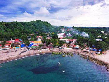 High angle view of town against cloudy sky