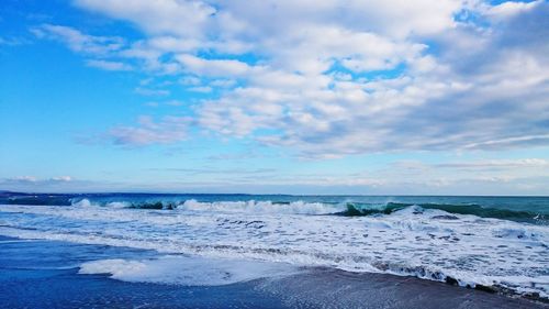 Scenic view of sea against cloudy sky