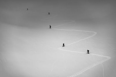 High angle view of people skiing on snowcapped mountain