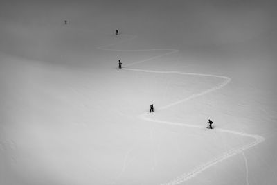 High angle view of people hiking on snowcapped mountain